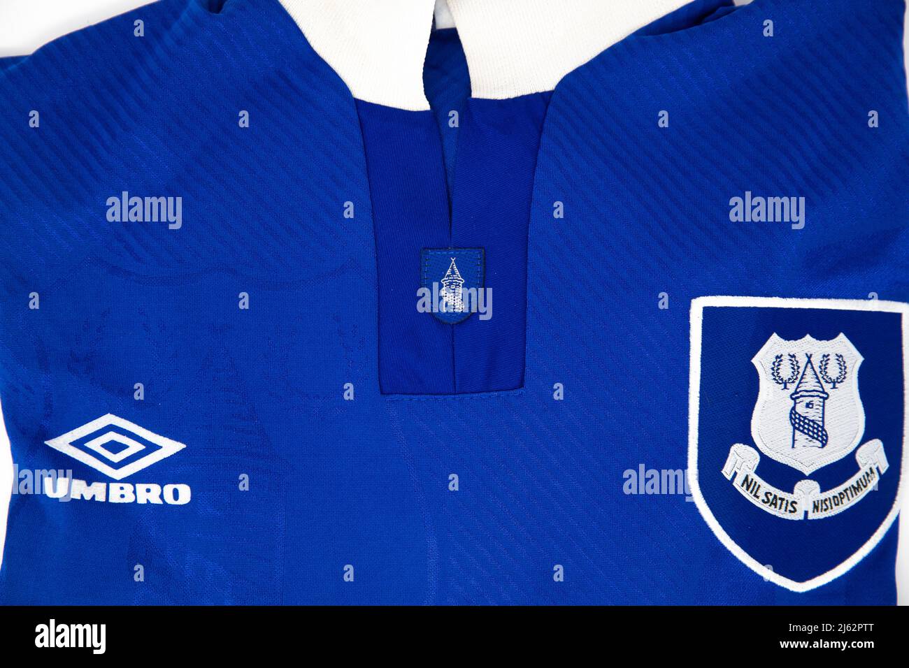 Everton Badge on a blue folded Umbro football shirt Stock Photo