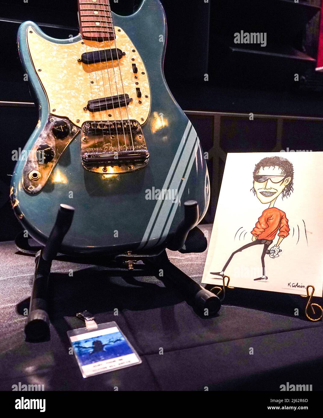 Kurt Cobain's original artwork of Michael Jackson wearing a red jacket, single white glove and sunglasses, and featuring Cobain's signature in the lower right corner, on display at the Hard Rock Cafe, London, before it goes up for auction, with an accompanying non-fungible token (NFT) included, at an estimate of 40,000 - 60,000 US dollars. Kurt Cobain's personally owned all access pass, from the 1993 Nirvana In Utero concert tour, on display at the Hard Rock Cafe, London, before it goes up for auction, at an estimate of 1,000 - 2,000 US dollars, Kurt Cobain's 1969 Fender Mustang Competition La Stock Photo