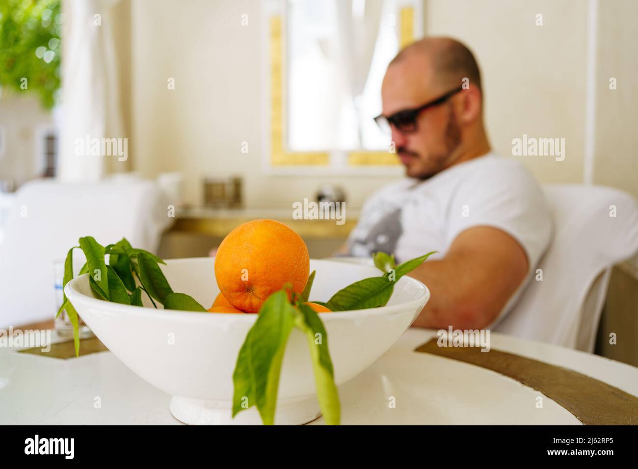 Tourist and Orange fruits in a vase in Moroccan Riad Stock Photo