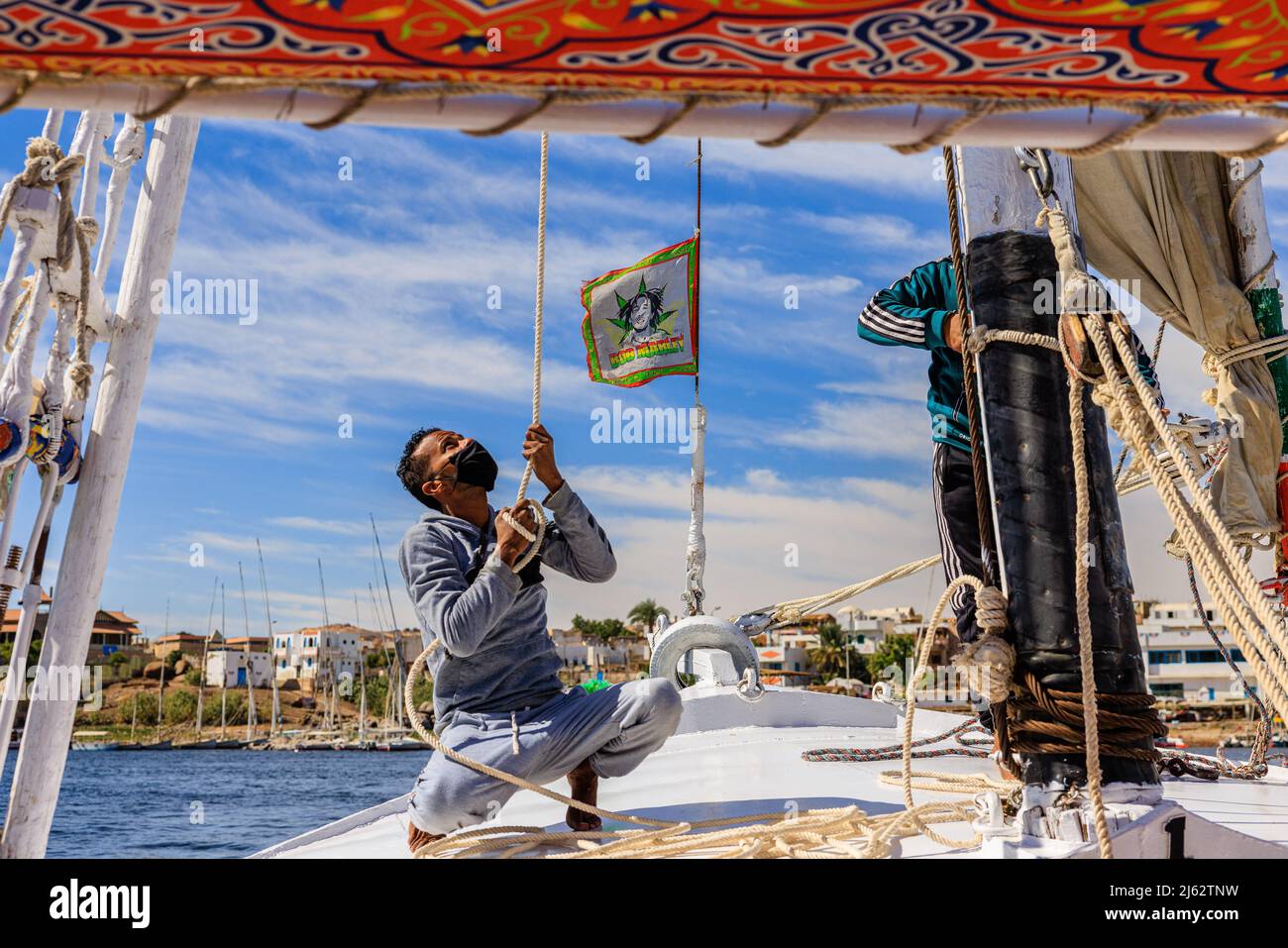covid safe travel on traditional felucca sailing boat on the nile as crew wwear face masks Stock Photo