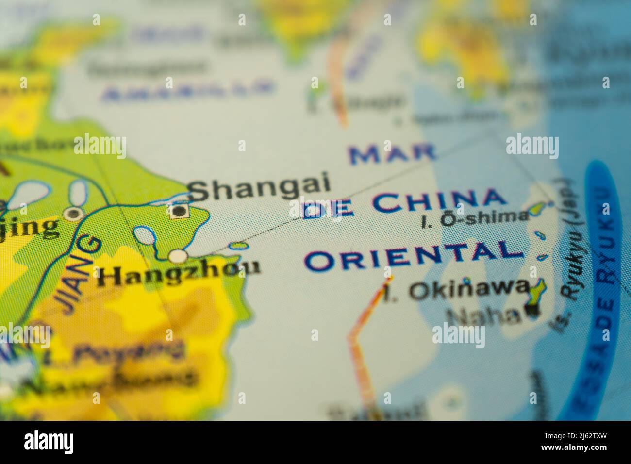 Close-up of the orographic map of Shanghai and the China Sea, with references in Spanish. Concept cartography, tourism, geography. Differential focus. Stock Photo