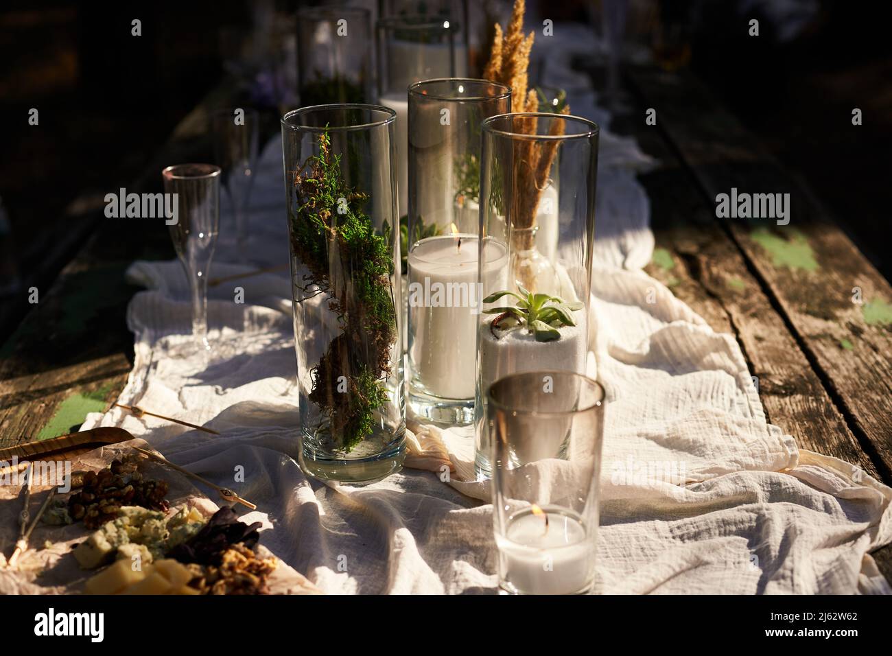 Wedding dinner table reception. Wedding table decoration - white branch  from a tree, crystal pendants, candles in glass spheres, on a white table  with Stock Photo - Alamy