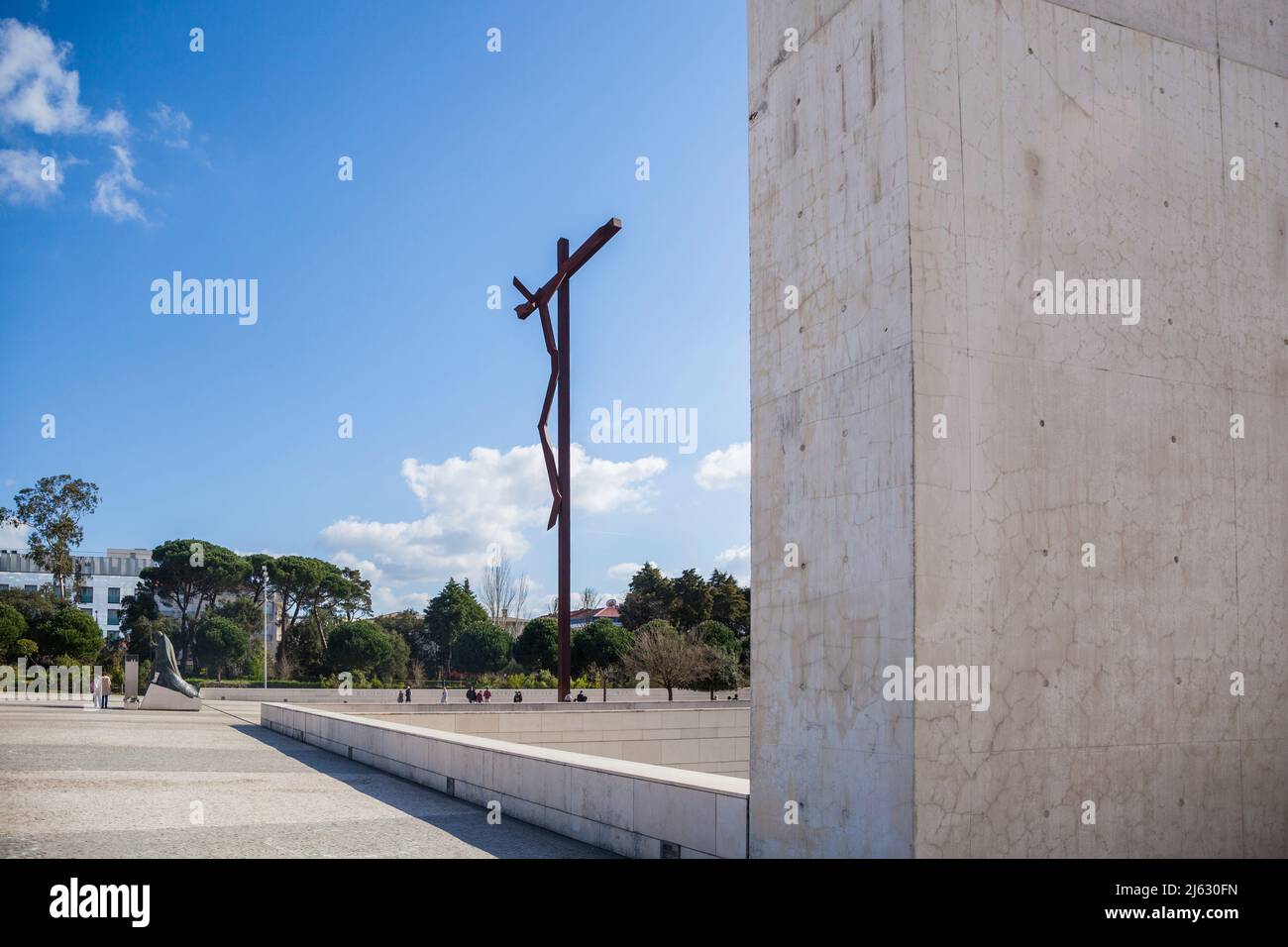 modern cross, called the high cross from Robert Schad in Fatima Portugal in the background a statue of the kneeling Pope Johannes Paul II Stock Photo