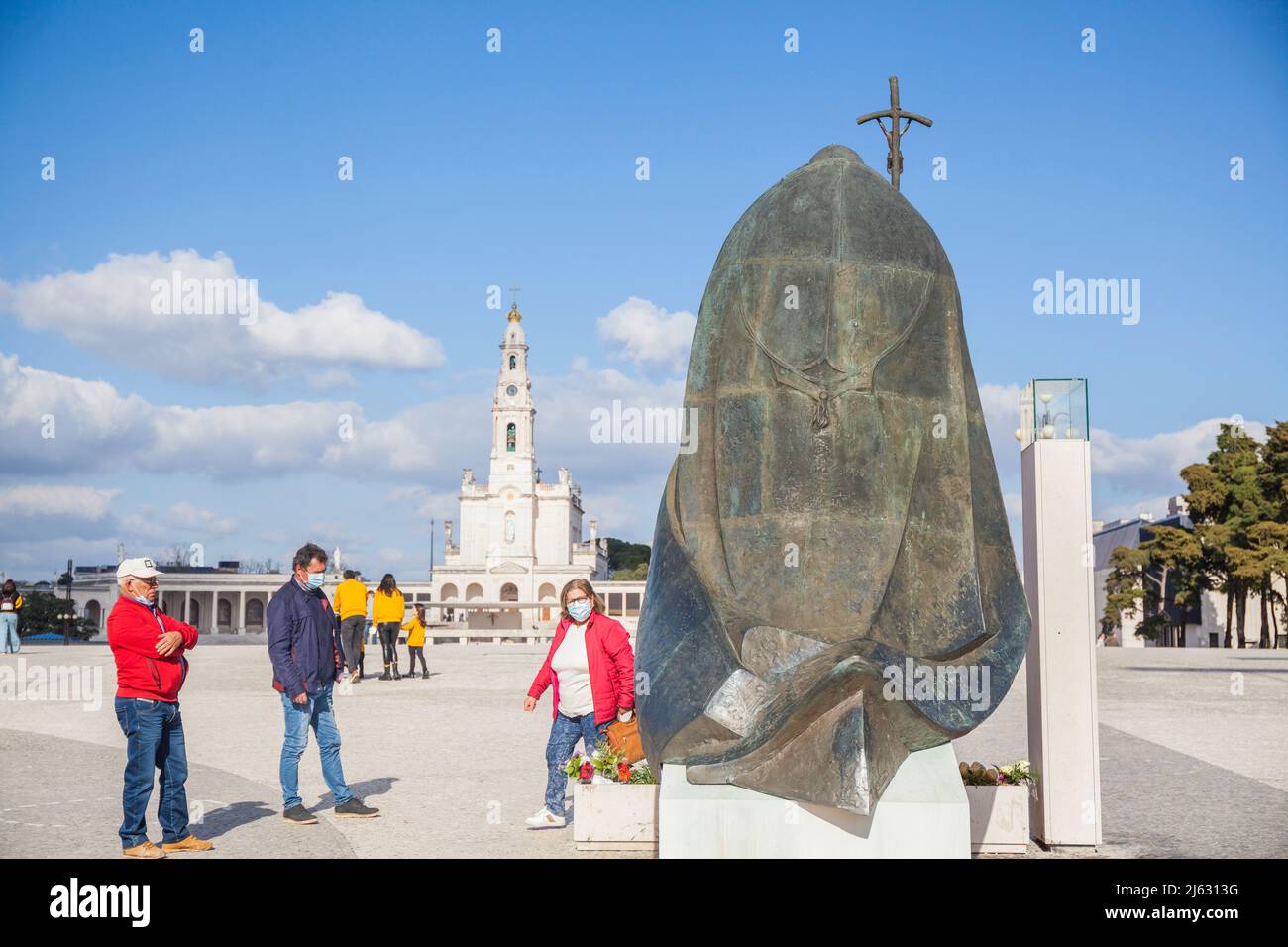kneeling Statue from Pope Johannes Paul II facing the Basilica of Our Lady of the Rosary in Fatima Portugal Stock Photo