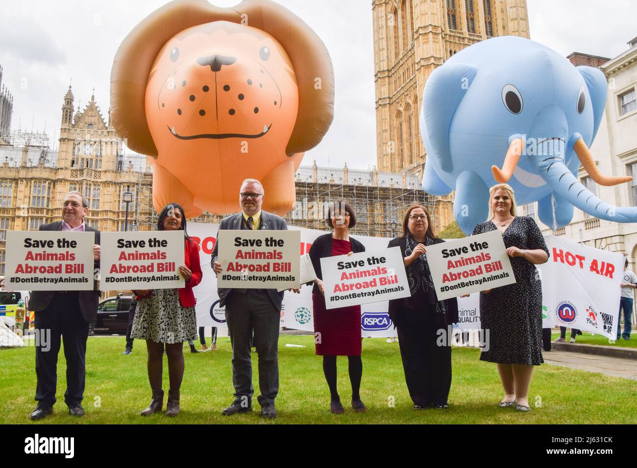 London, England, UK. 27th Apr, 2022. L-R: SNP MP JOHN MCNALLY, Labour MP RUPA HUQ, SNP MP MARTYN DAY, SNP MP PATRICIA GIBSON, SNP MP KIRSTEN OSWALD, and Labour MP ALEX DAVIES-JONES. Various animal welfare organisations gathered outside Parliament and flew huge lion and elephant balloons in response to reports that the government will drop the Animals Abroad Bill. The organisations are calling on the government to go through with their promise to ban the import of hunting ''˜trophies', fur and foie gras to the UK, and the promotion of tourist elephant rides abroad. (Credit Image: Credit: ZUMA P Stock Photo