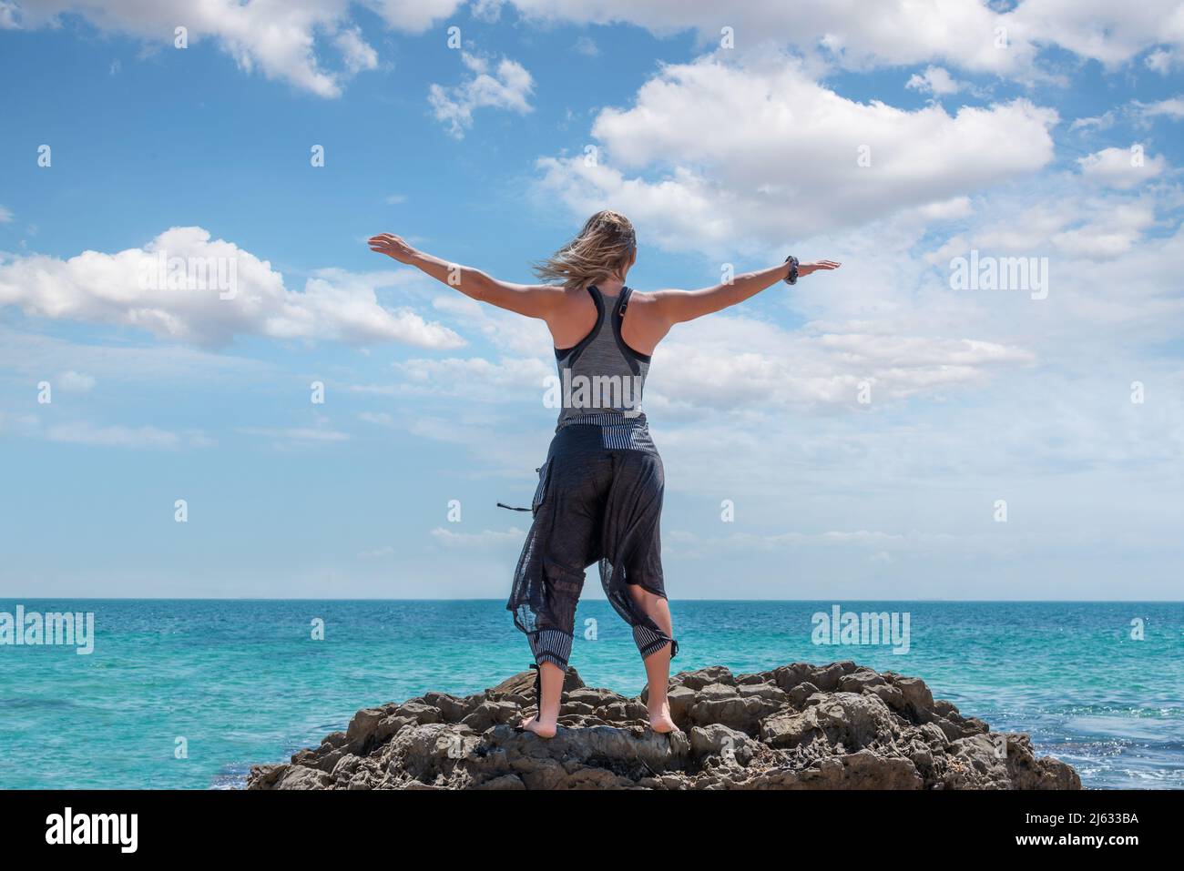 Woman standing sea raised arms hi-res stock photography and images - Alamy
