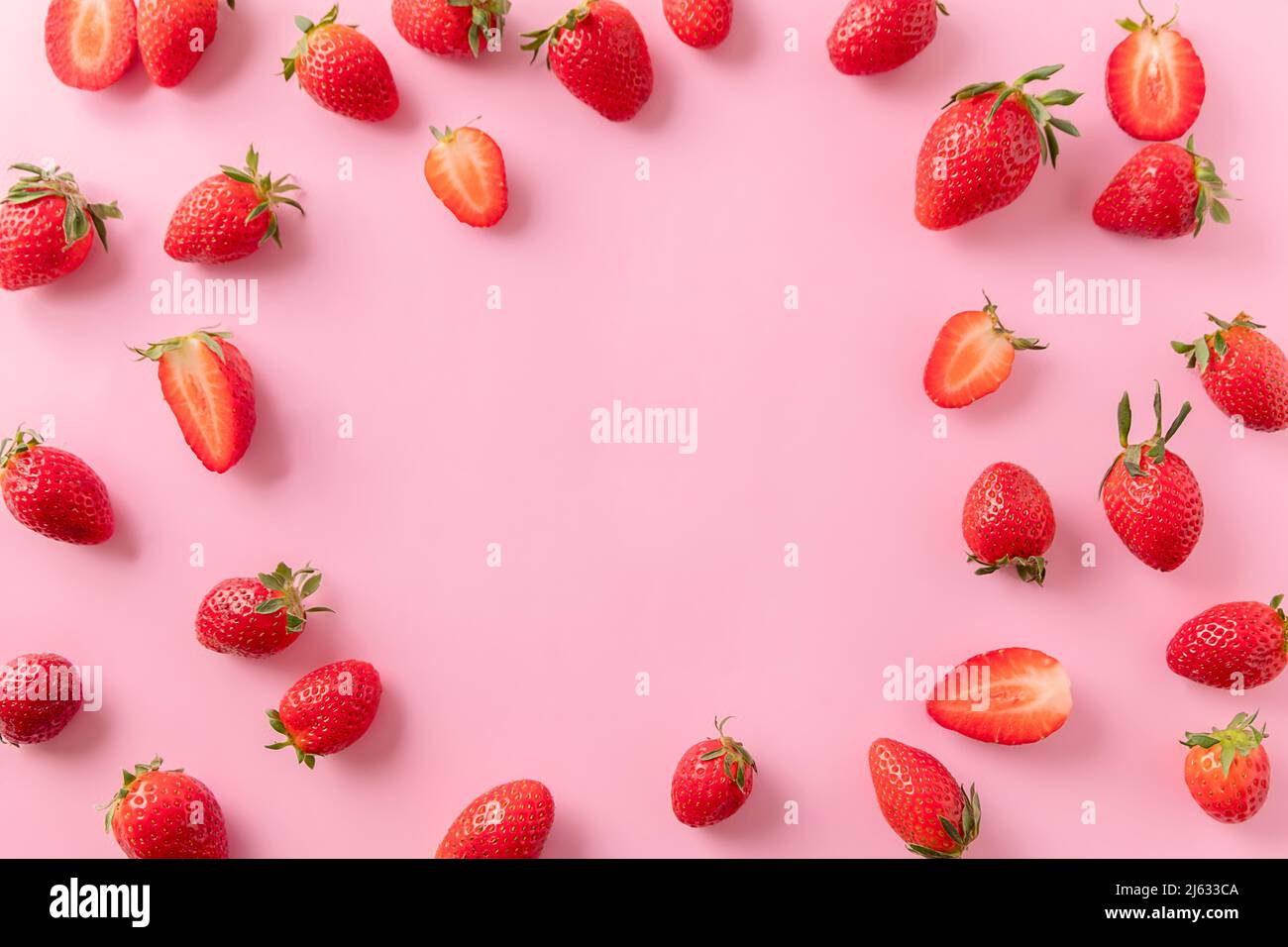 Juicy ripe strawberries on pink background, top view. Strawberry frame, copy text, top view Stock Photo