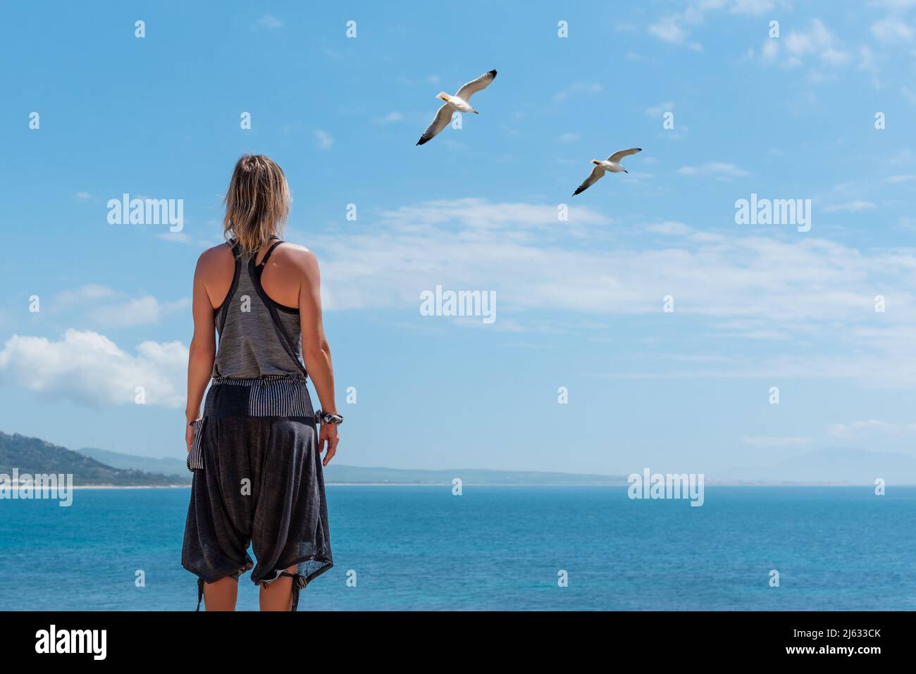 Woman standing in front of sea hi-res stock photography and images - Alamy