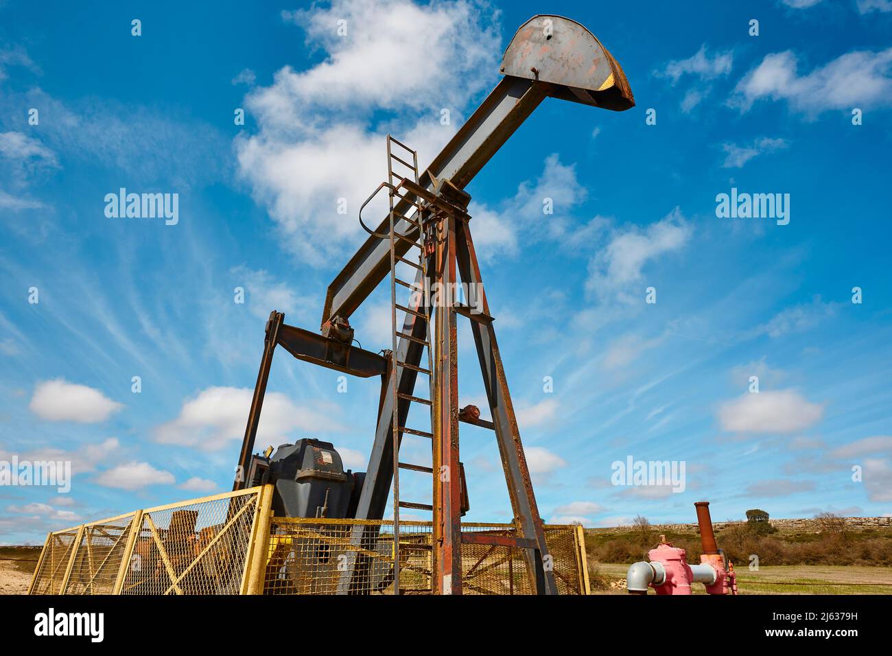 Oil pumping machine. Pump jack. Petroleum extraction. Global warming Stock Photo