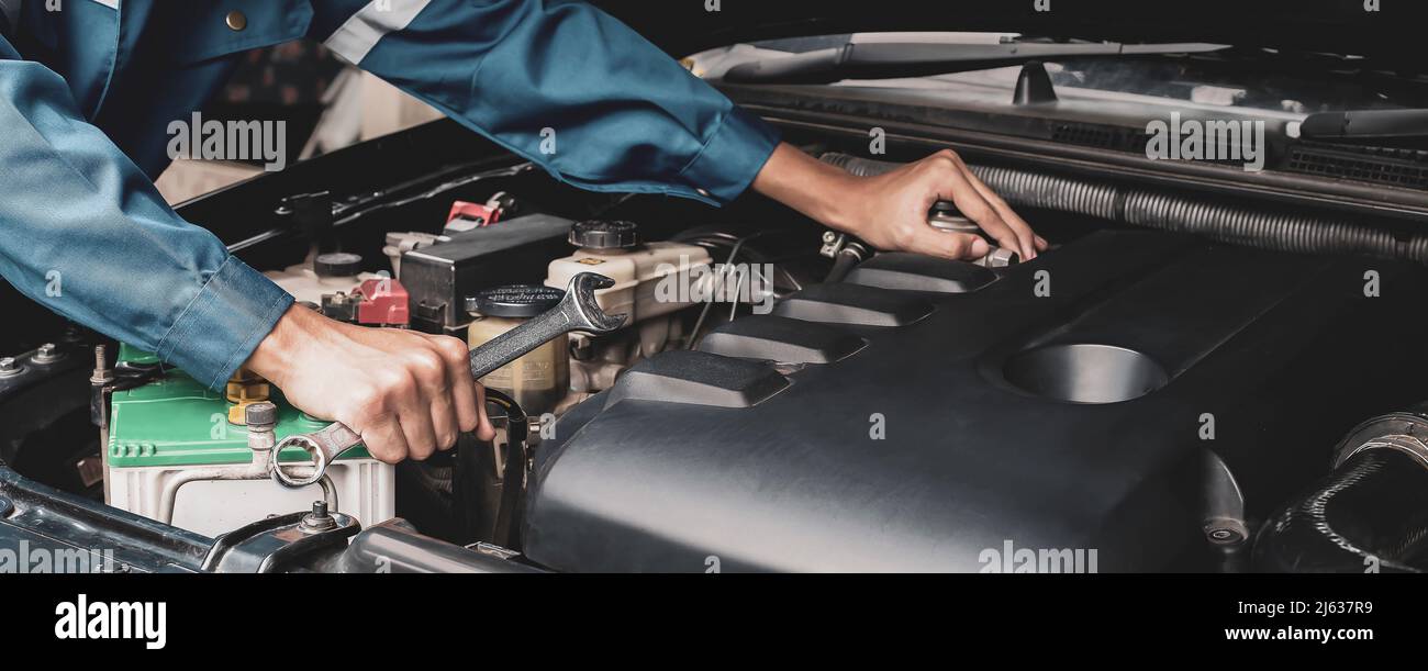 Car mechanic working on car engine, car maintenance concept Stock Photo