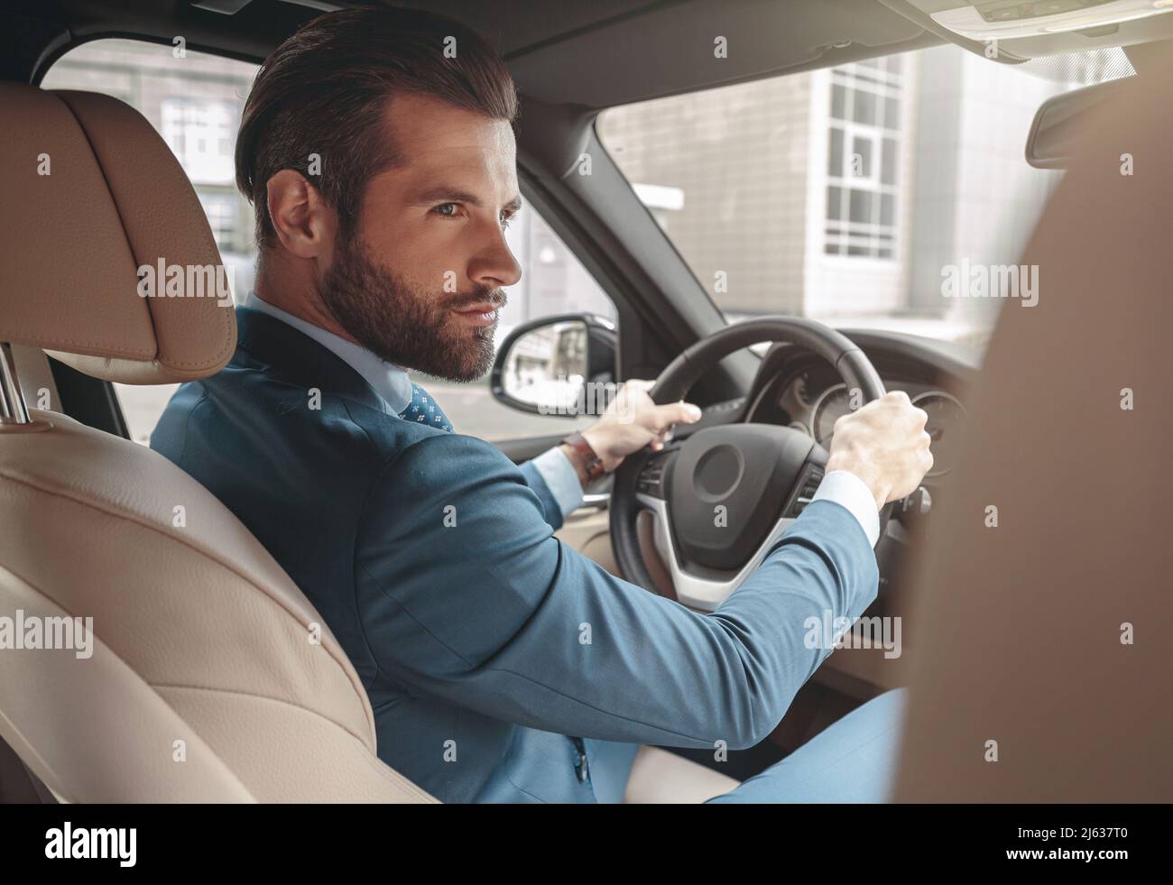 Elegant bearded male in suit traveling by automobile Stock Photo