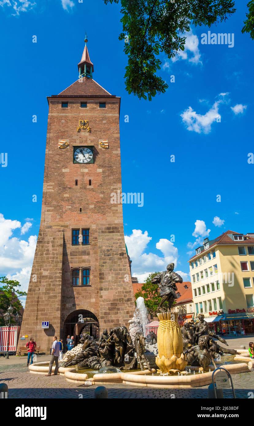 Lovely view of the popular White Tower (Weißer Turm) and the famous sculptural bronze fountain Marriage-Merry-Go-Round (Ehekarussell) in Nürnberg,... Stock Photo