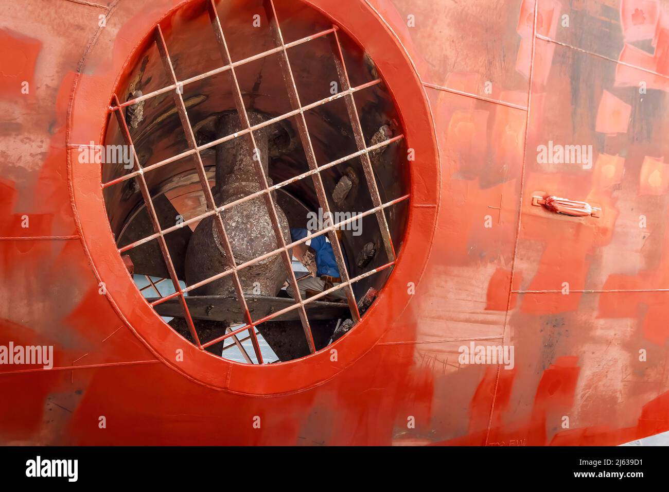 Close up view of a ship yard worker inside big ship thruster tunnel inspecting bow thruster Stock Photo