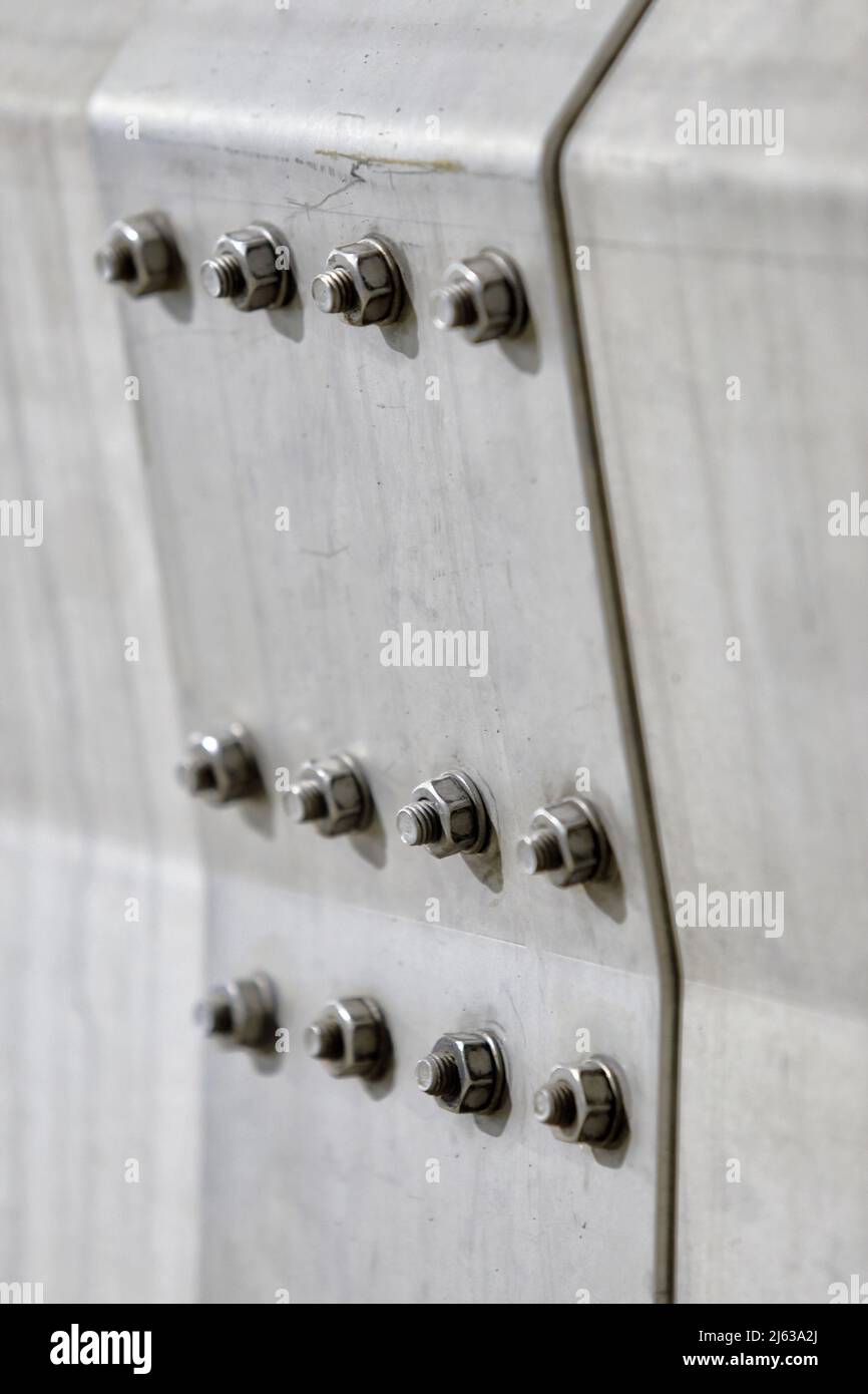 A joining plate in an industrial conveyorapplication, with 12 bolts evenly spaced and torqued to the same amount to prevent any misalignment. Stock Photo