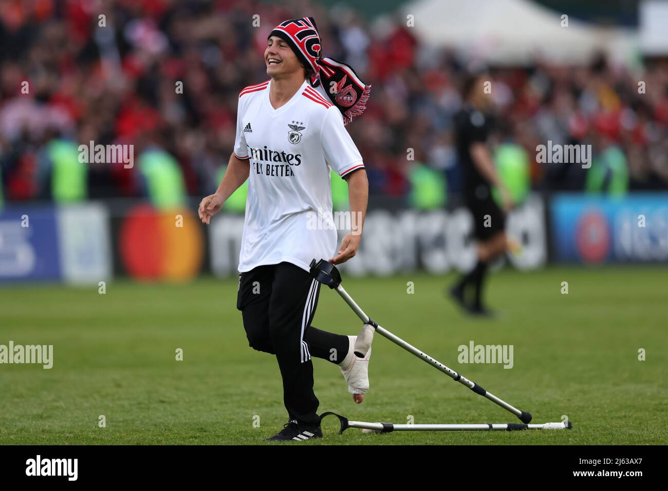 Nyon, Switzerland, 25th April 2022. Joao Neves of SL Benfica abandons his crutches to celebrate with team mate Andre Gomes following the final whistle of UEFA Youth League match at Colovray Sports Centre, Nyon. Picture credit should read: Jonathan Moscrop / Sportimage Stock Photo