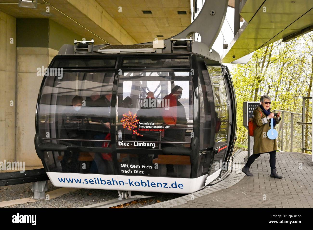 Koblenz, Germany - April 2022: Tour guide getting off a cable car at the station for the Ehrenbreitstein fortress above the town Stock Photo