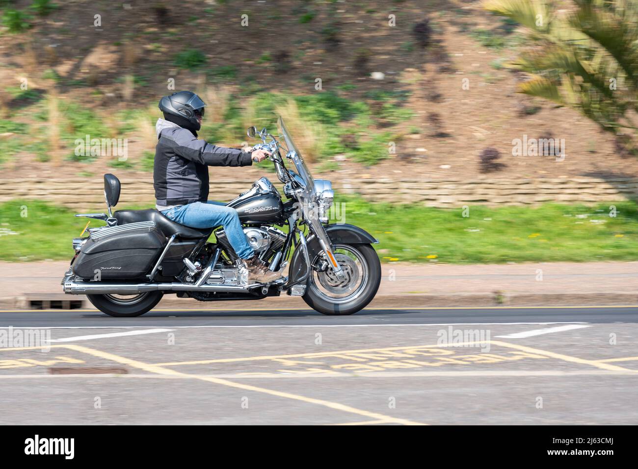 Harley-Davidson FL Road King motorcycle with rider, riding on Western Esplanade, Southend on Sea, Essex, UK. Classic American motorbike Stock Photo