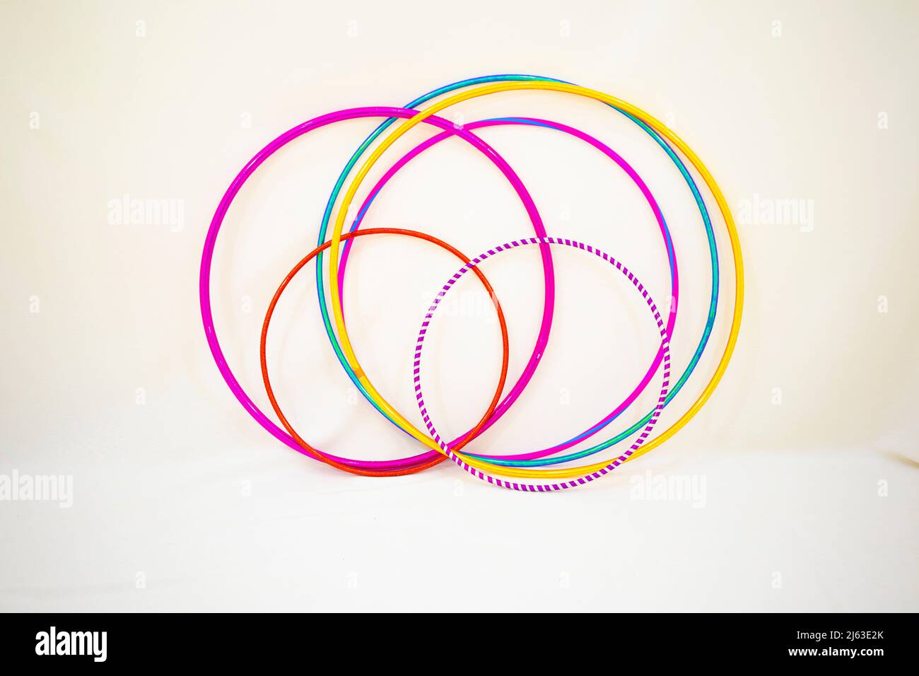 group of hula hoop various colors on white background on wall Stock