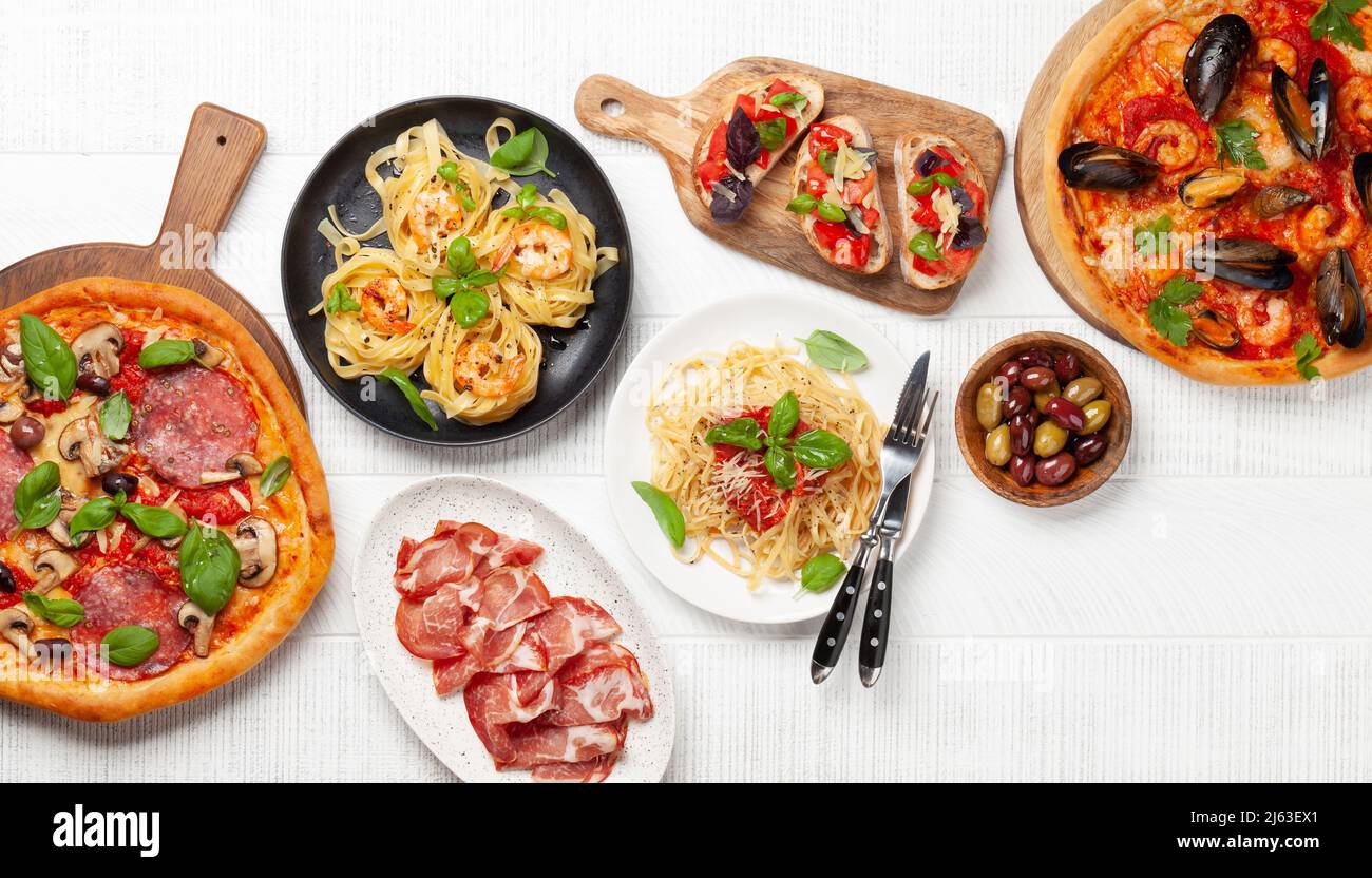 Italian cuisine. Pasta, pizza, olives and antipasto toasts. Flat lay Stock Photo Alamy