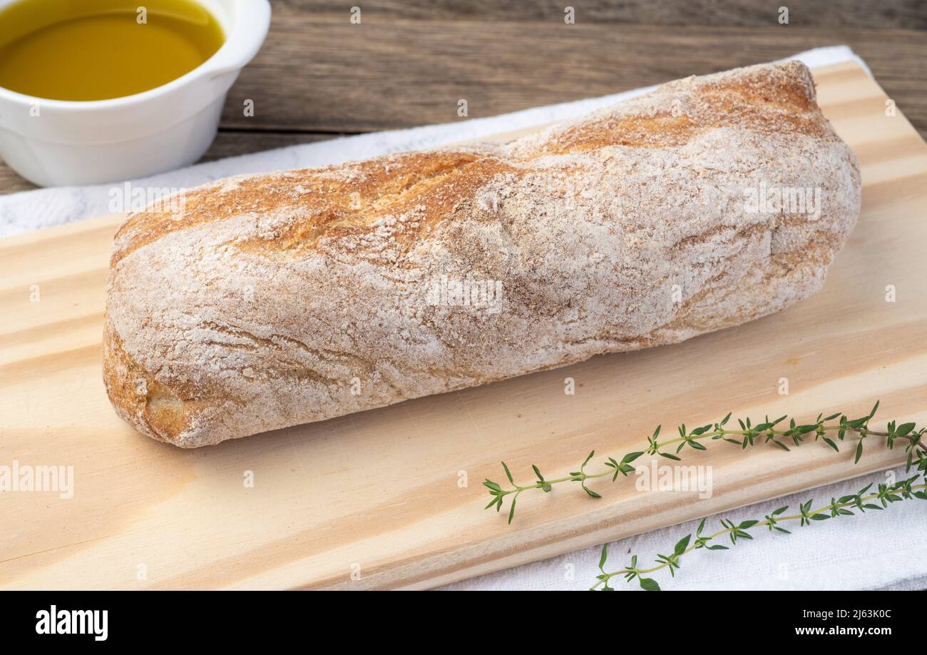 Traditional homemade ciabatta bread with slices and olive oil over wooden  table Stock Photo - Alamy