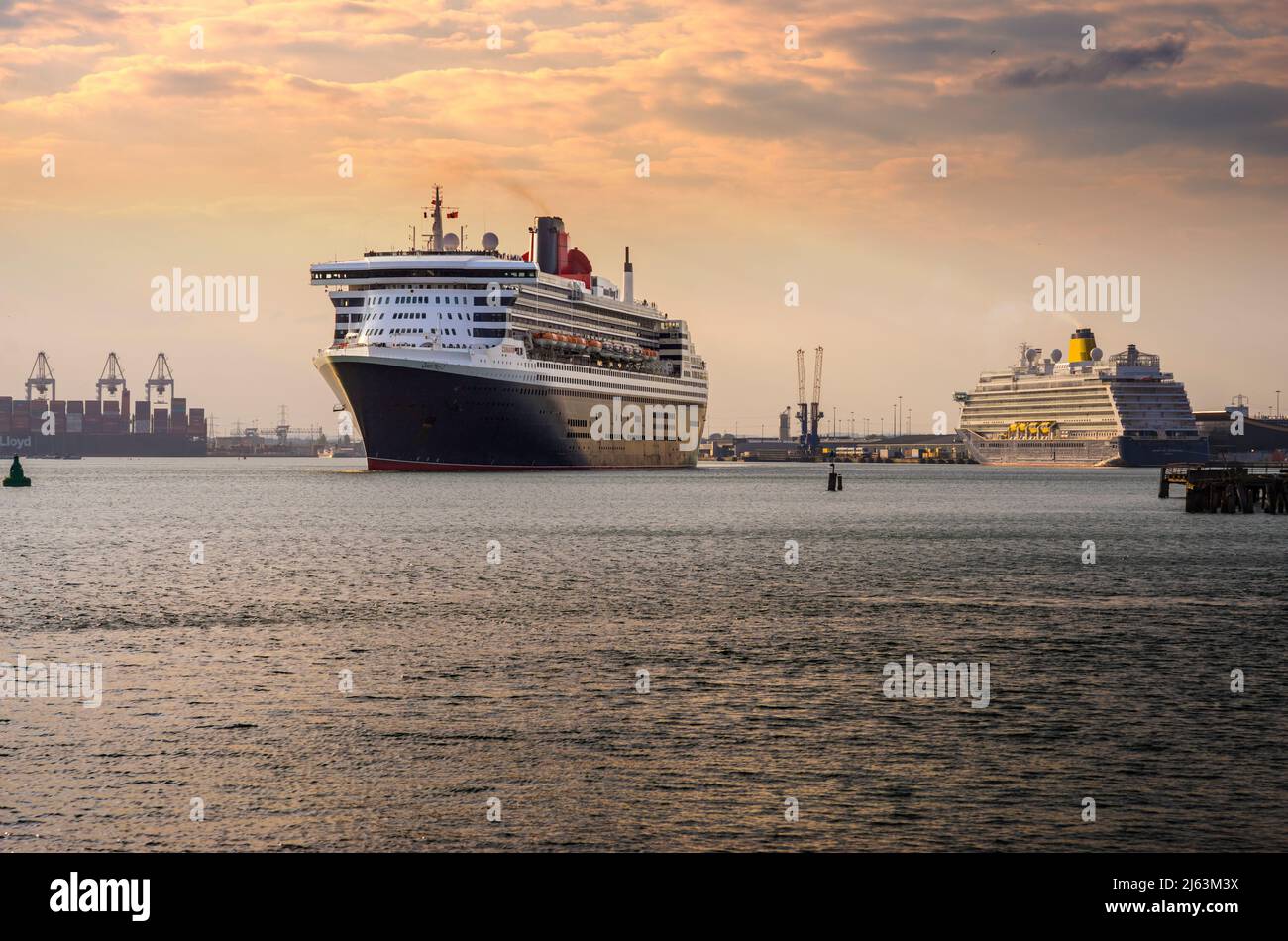 Cunard liner Queen Mary 2 passing Saga cruise ship Spirit of Adventure as she departs Southampton for New York on 24 April 2022. Southampton, England Stock Photo
