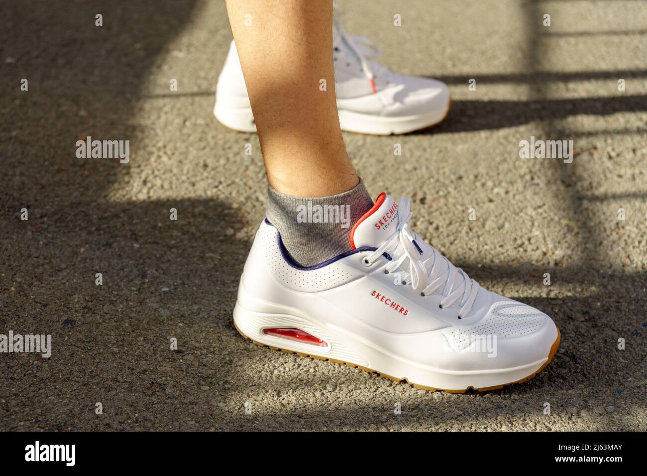 Tyumen, Russia-April 27, 2022: Skechers white sneakers logo Headquartered in Manhattan Beach, California, the brand was founded in 1992 Stock Photo - Alamy