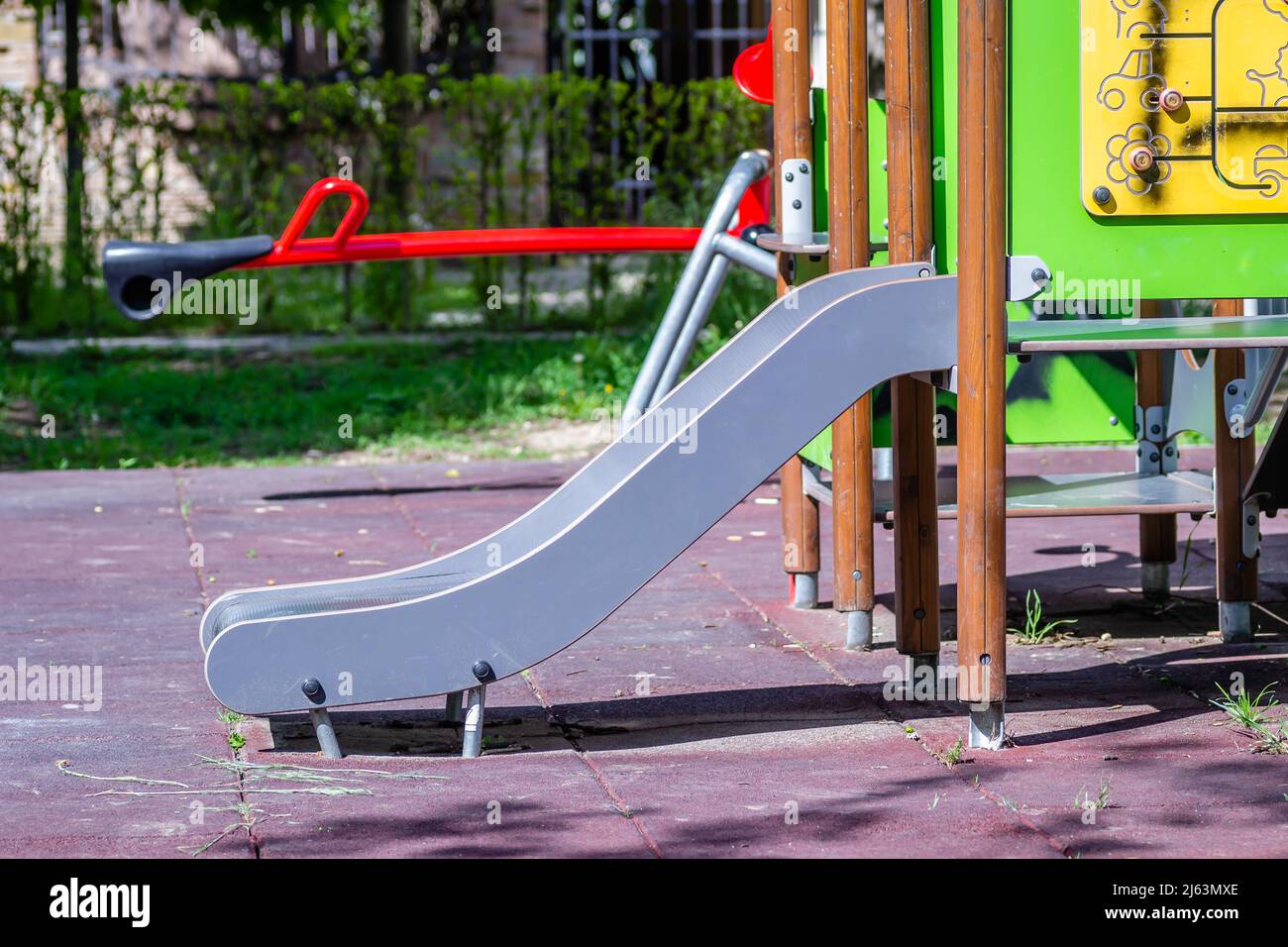 Colorful playground equipment with a variety of toys, including a slide and games to play on a sunny, early spring day. Stock Photo