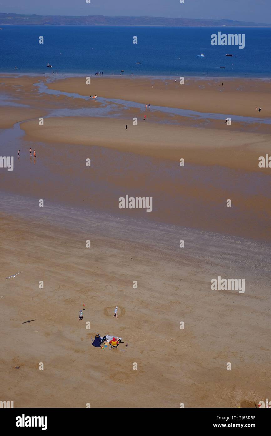 People enjoying early Spring sunny weather on Tenby North Beach, Tenby, Pembrokeshire, Wales UK Stock Photo