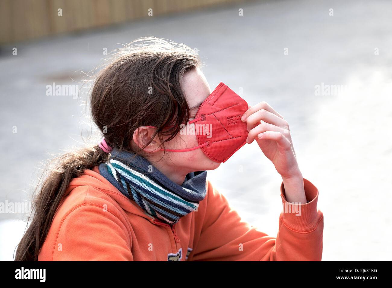 Teenage boy wearing face mask outside. Stock Photo