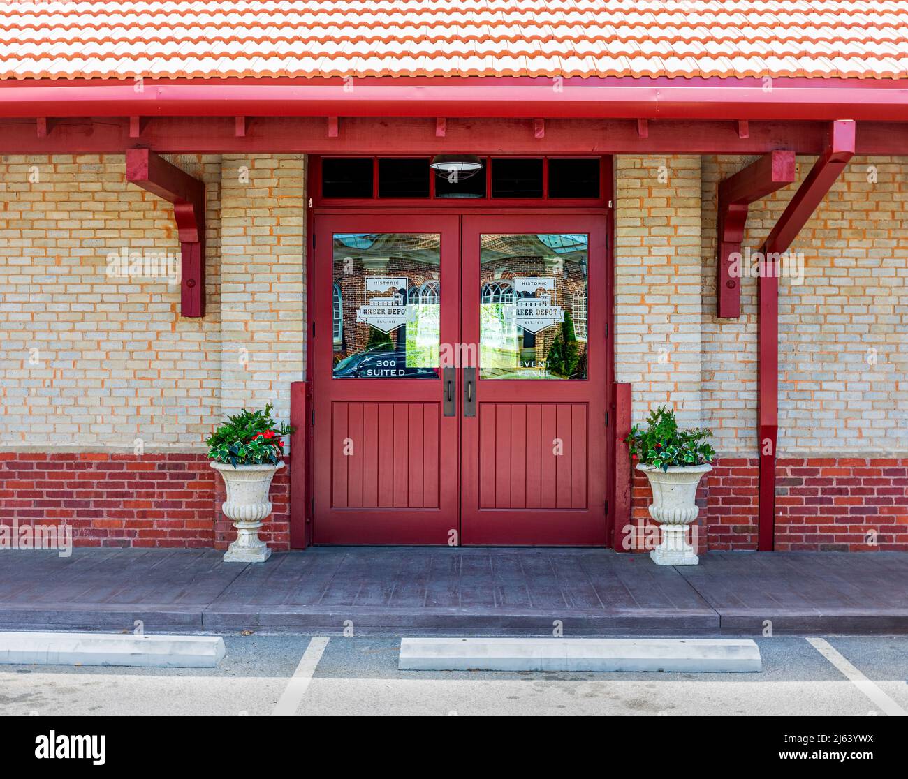 GREER, SC, USA 24 APRIL 2022: Closeup view of red double door entrance to the Greer Depot event venue. Stock Photo