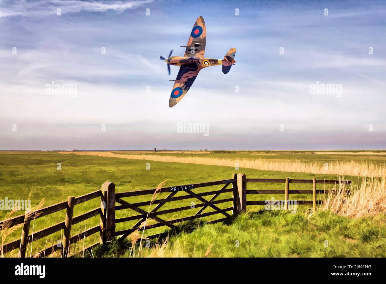 Spitfire Mk5 passing low over the flat Norfolk countryside. Stock Photo