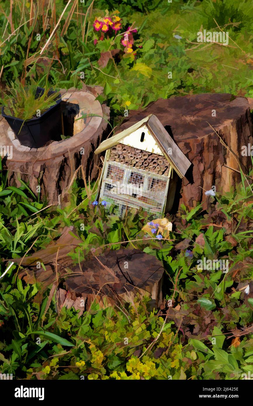 Insect house or Bug hotel on the ground in a nature Garden. Stock Photo