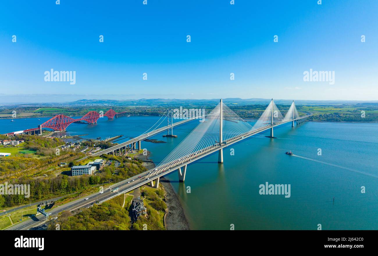 Aerial view from drone of the Three Bridges ( Queensferry Crossing, Forth Road Bridge and the Forth Bridge) that cross the Firth of Forth at North Que Stock Photo