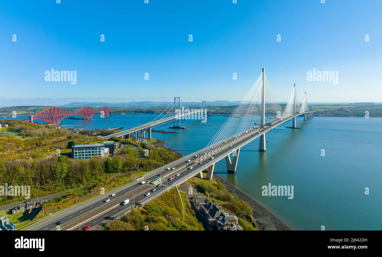 Aerial view from drone of the Three Bridges ( Queensferry Crossing, Forth Road Bridge and the Forth Bridge) that cross the Firth of Forth at North Que Stock Photo