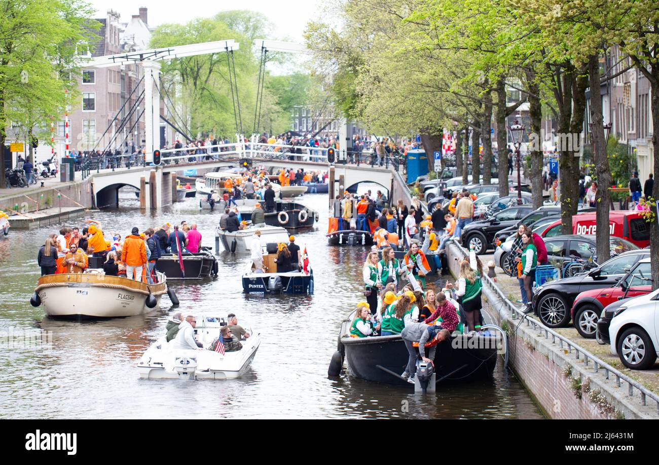 Amsterdam, Netherlands. 27th Apr, 2022. People celebrate King's Day on boats on a canal in Amsterdam, the Netherlands, on April 27, 2022. King's Day (Koningsdag in Dutch) is a national holiday in the Kingdom of the Netherlands, celebrated on April 27, King Willem-Alexander's birthday. Credit: Sylvia Lederer/Xinhua/Alamy Live News Stock Photo