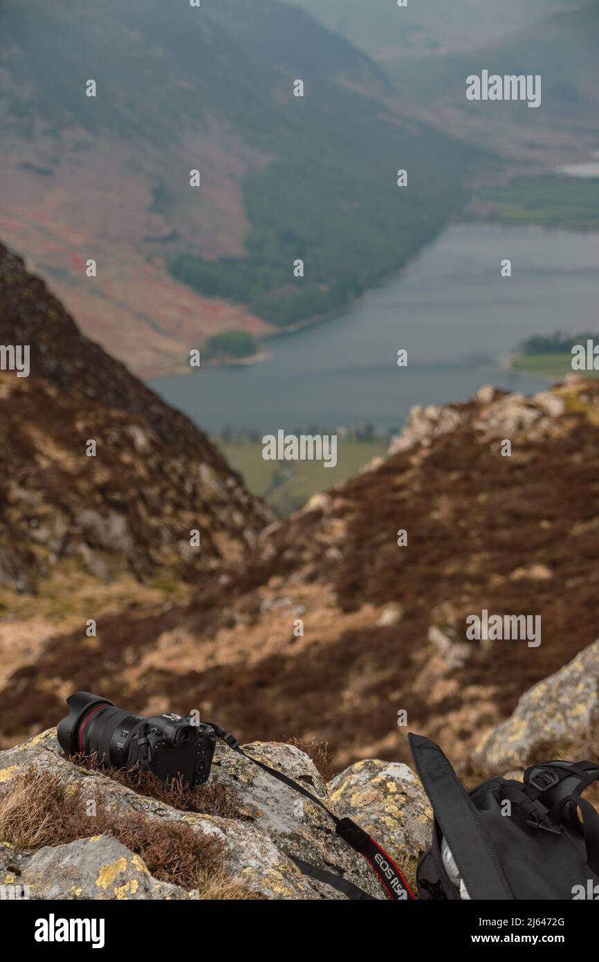 Canon R5, Canon's flagship mirrorless camera, sitting on a rock above the lake of Buttermere in the Lake District National Park, Cumbria, England, UK Stock Photo