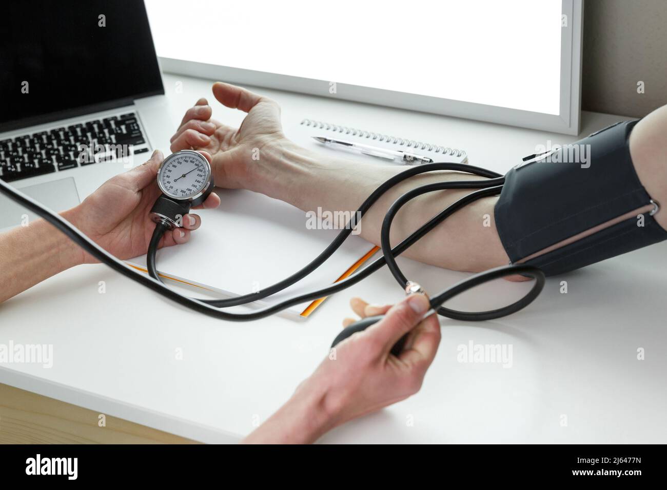 Doctor measuring blood pressure in a clinic.  Healthcare industry concept Stock Photo