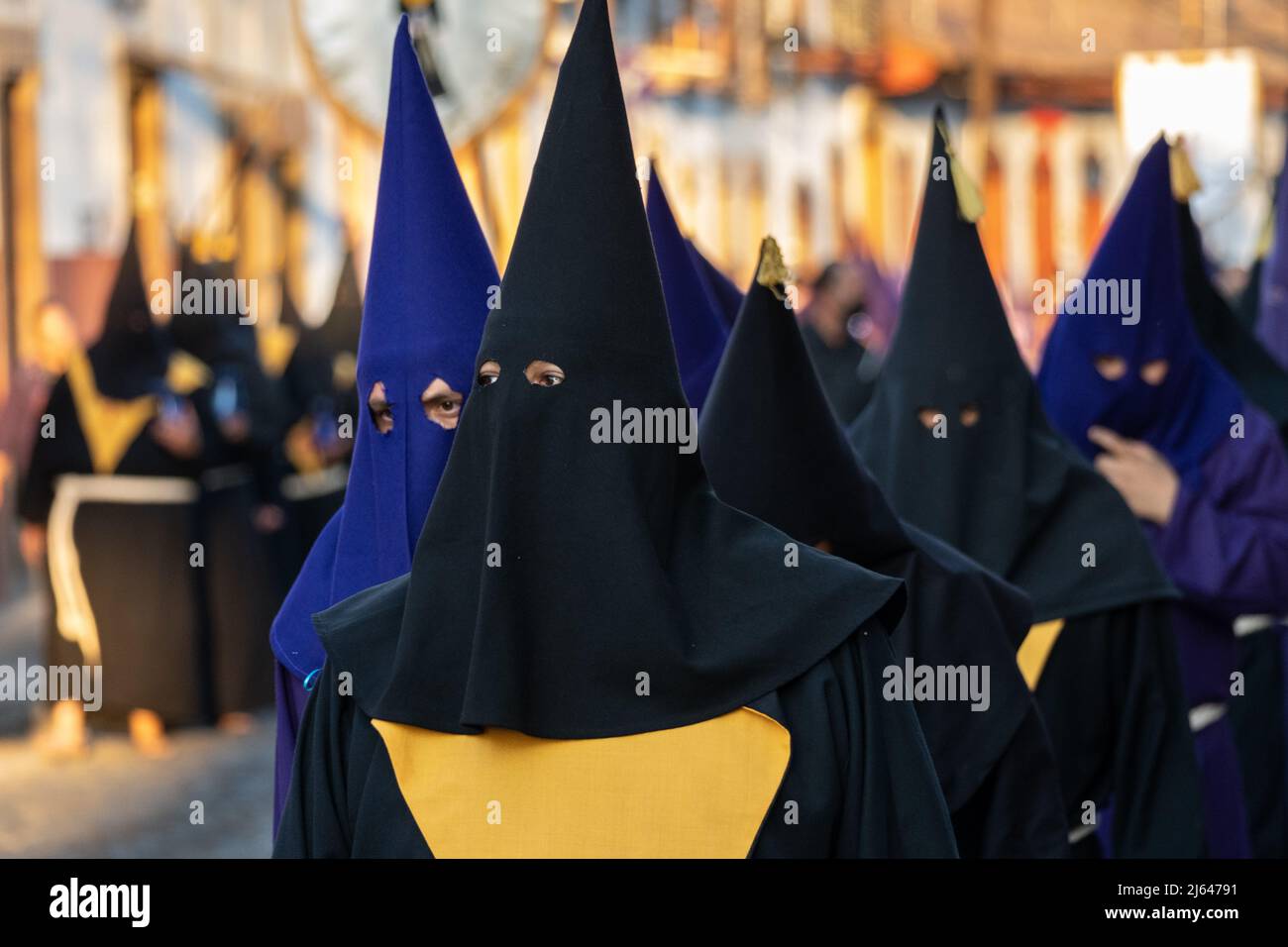 Roman Catholic hooded penitents wearing traditional capirotes, hold a procession of silence on Holy Saturday, April 16, 2022 in Patzcuaro, Michoacan, Mexico. The small indigenous town retains traditions from Colonial Spanish rule including the confraternity of penitents during Holy Week. Stock Photo