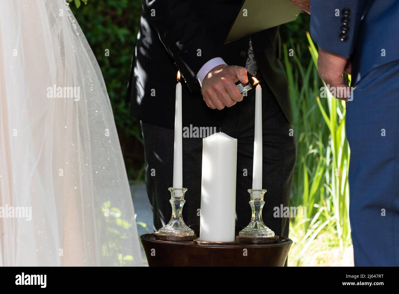 Lighting the individual candles for the bride and groom that will