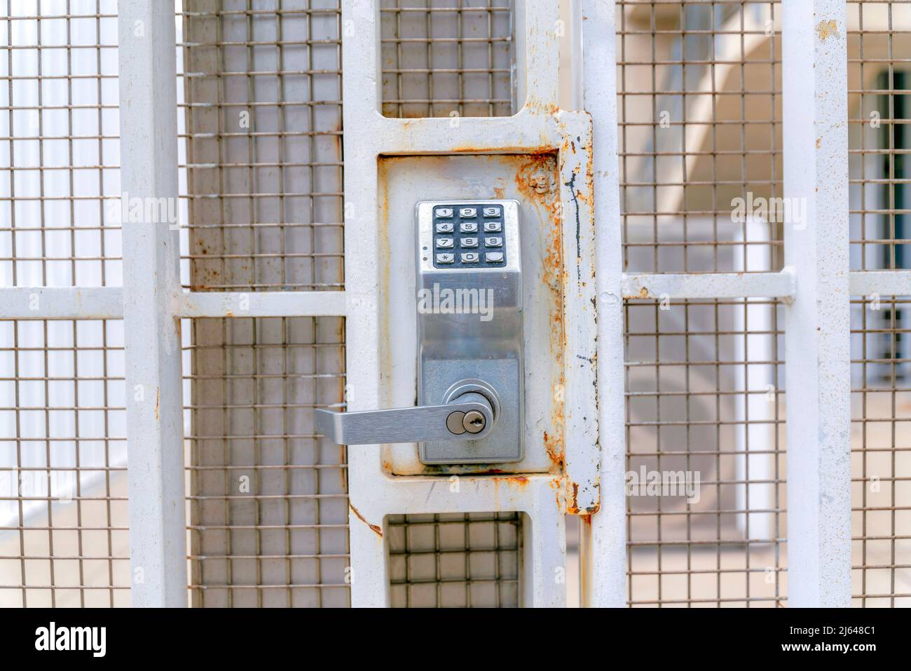 Digital key access lock on a beige metal gate at Silicon Valley, San