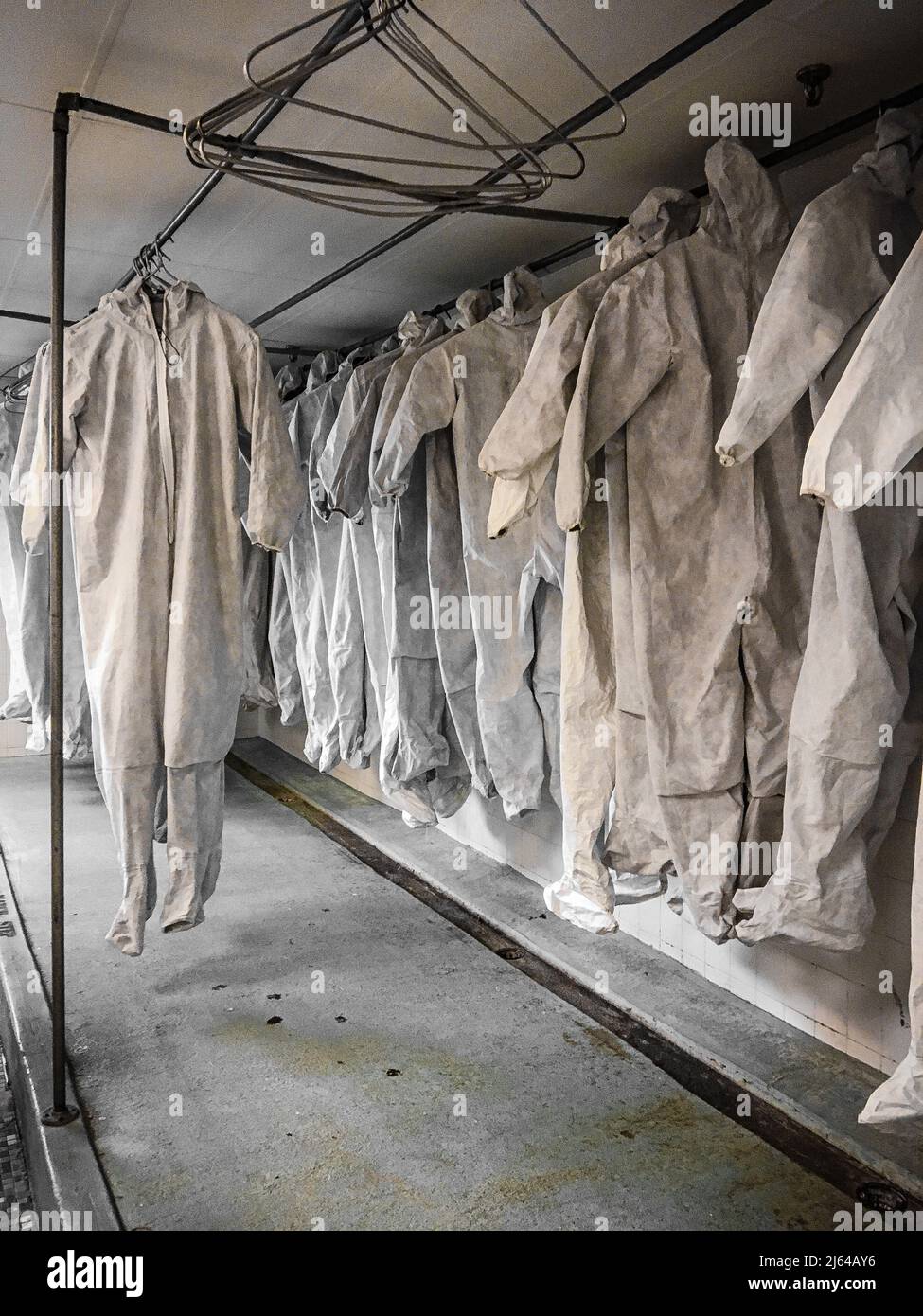Hazmat suits hanging to dry Stock Photo Alamy