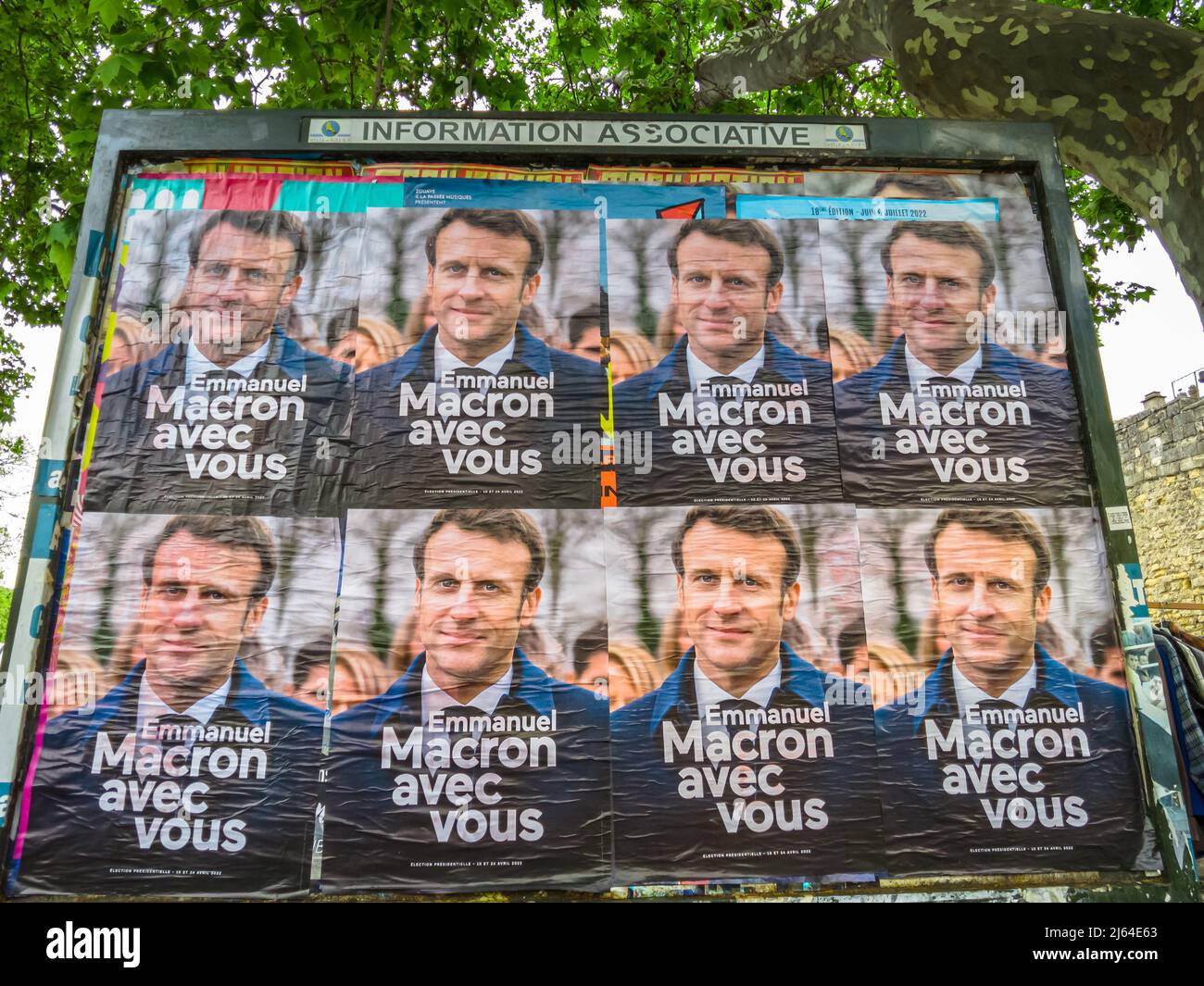 Arles, Provence, France - April 20, 2022: Emmanuel Macron electoral posters on a street panel of Arles town for the French presidential election of Stock Photo