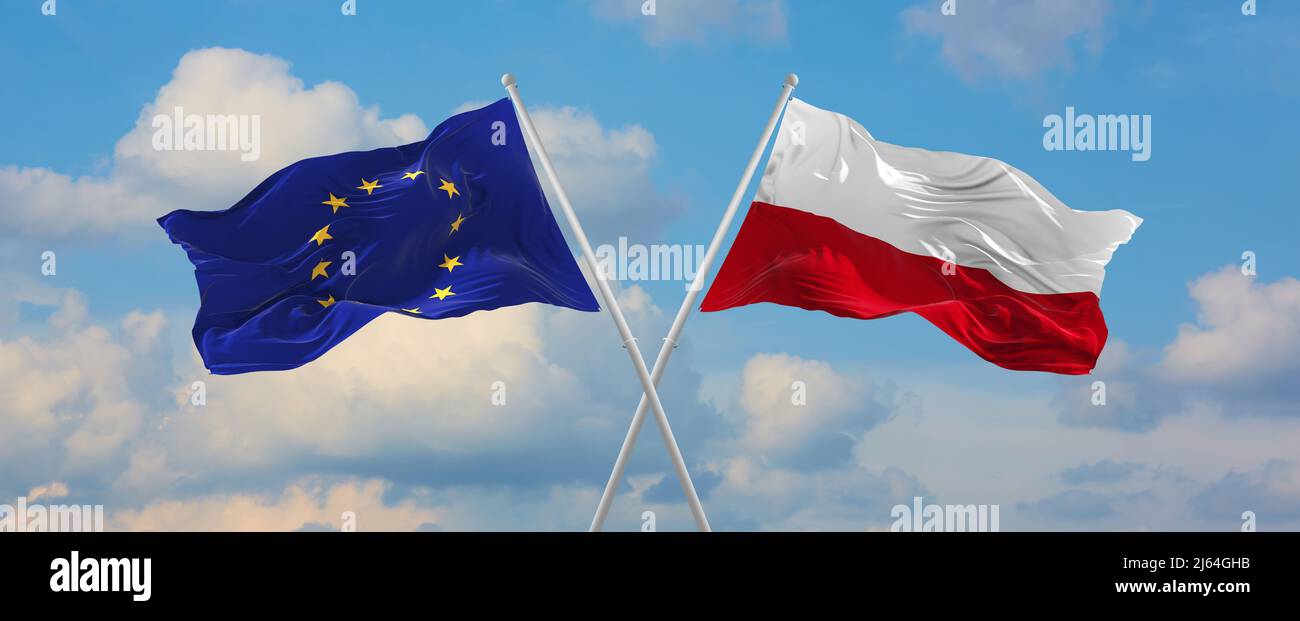 two crossed flags The European Union and Poland waving in wind at ...