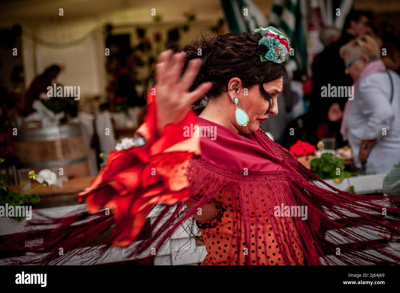Barcelona, Spain. April 27, 2022, Barcelona, Spain: A woman wearing in traditional Andalusian dress dances Sevillanas during La Feria de Abril (April Fair) held in Barcelona's Forum Park. The Feria de Abril in Barcelona is a folkloric festival of Andalusian roots that has been celebrated in Catalonia for almost 50 years. Credit: Jordi Boixareu/Alamy Live News Credit:  Jordi Boixareu/Alamy Live News Stock Photo