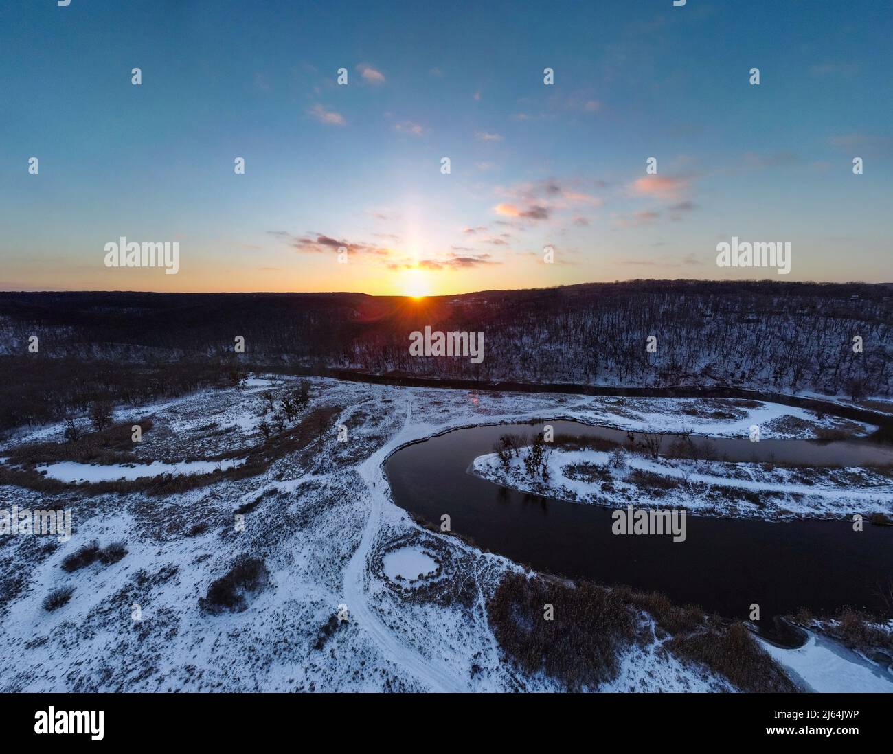 Winter aerial wide panorama view on snowy river curve with scenic reflection. Zmiyevsky region on Siverskyi Donets River in Ukraine. Sunset sun shinin Stock Photo