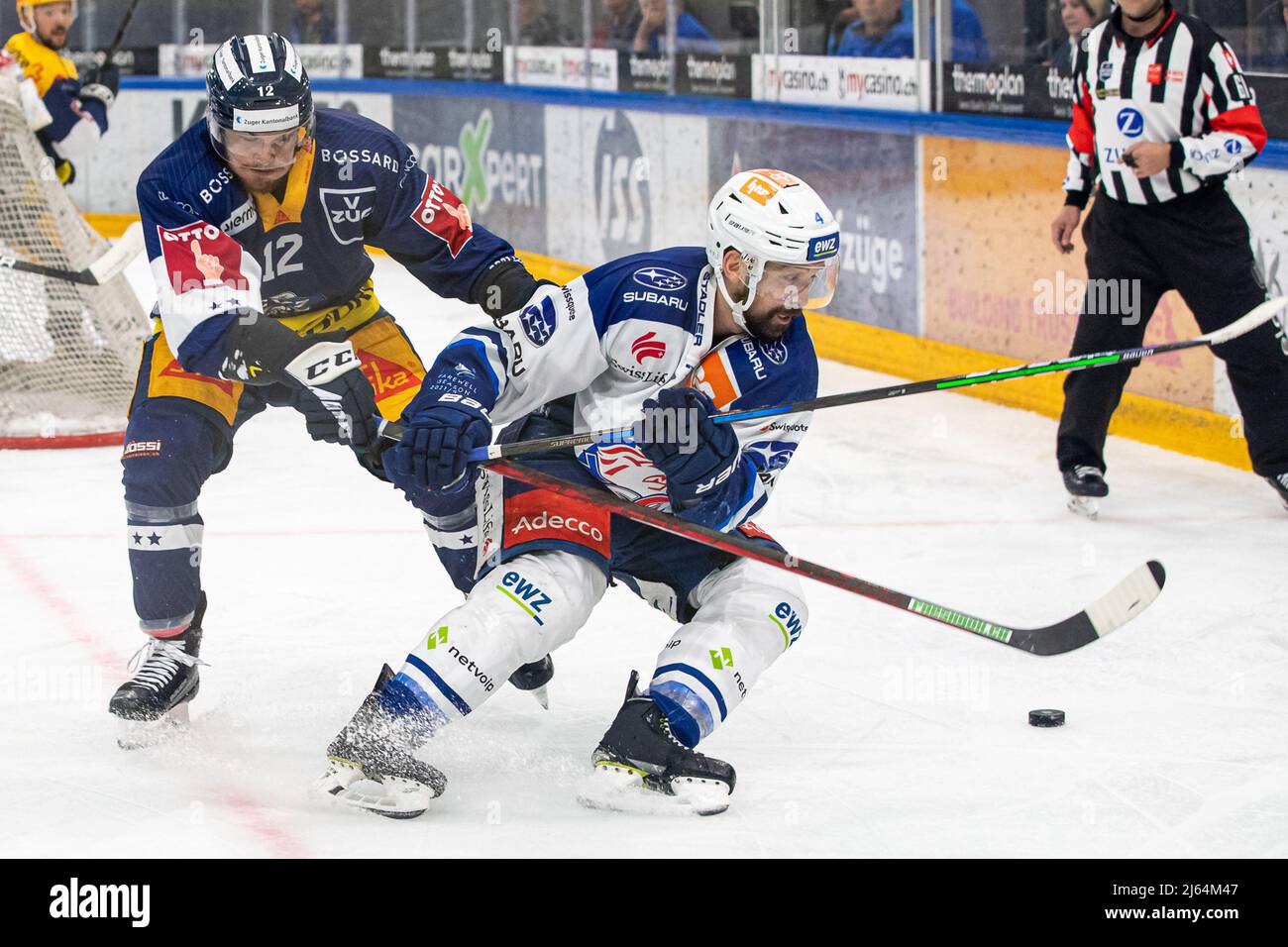Yannick Zehnder 12 (EV Zug) chases 4 Patrick Geering (ZSC) during the