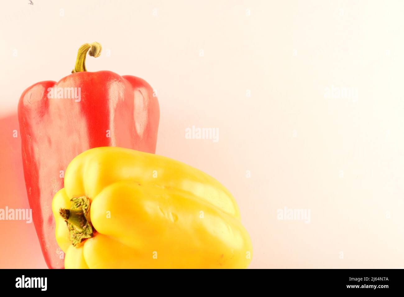 Red and yellow pepper on white background Stock Photo - Alamy