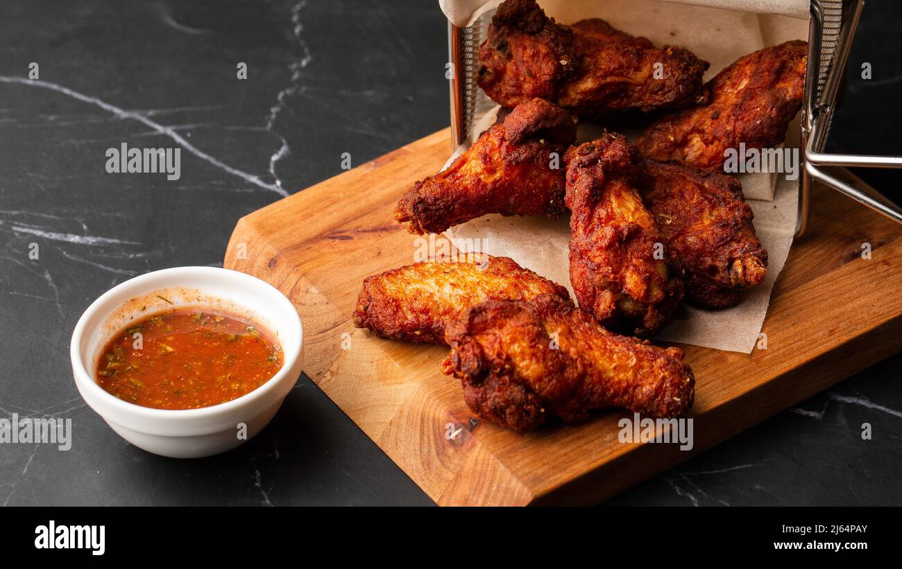 Fried Chicken Wings Covered in True Hot BBQ Sauce served with red hot