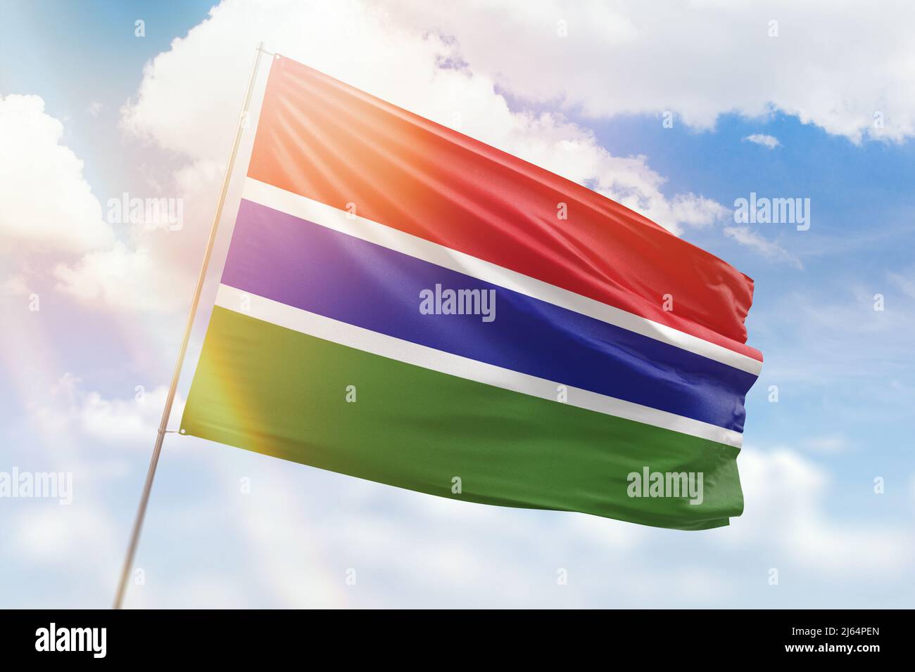 Sunny blue sky and a flagpole with the flag of gambia Stock Photo - Alamy
