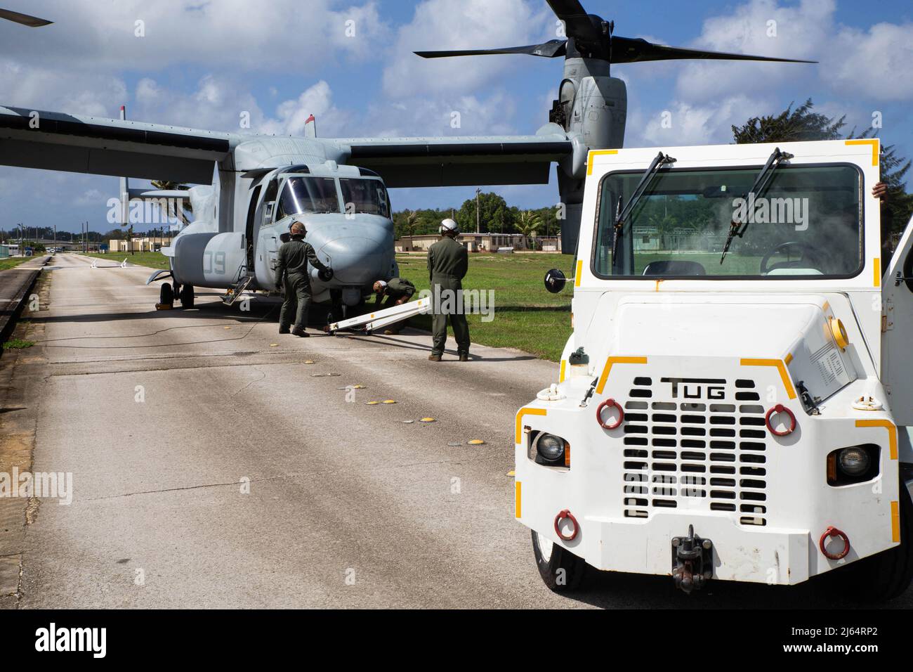 U.S. Marines with Marine Medium Tiltrotor Squadron 363, 1st Marine Aircraft Wing (MAW), prepare to move an MV-22 Osprey after landing at Naval Base Guam, April 24, 2022. 1st MAW serves as the Aviation Combat Element of the III Marine Expeditionary Force headquartered on the island of Okinawa, Japan and provides support to the Indo-Pacific area. (U.S. Marine Corps photo by Gunnery Sgt. Rubin J. Tan) Stock Photo